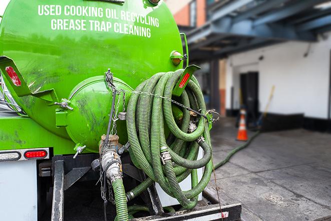 a service truck pumping grease from a restaurant's grease trap in Alvin TX